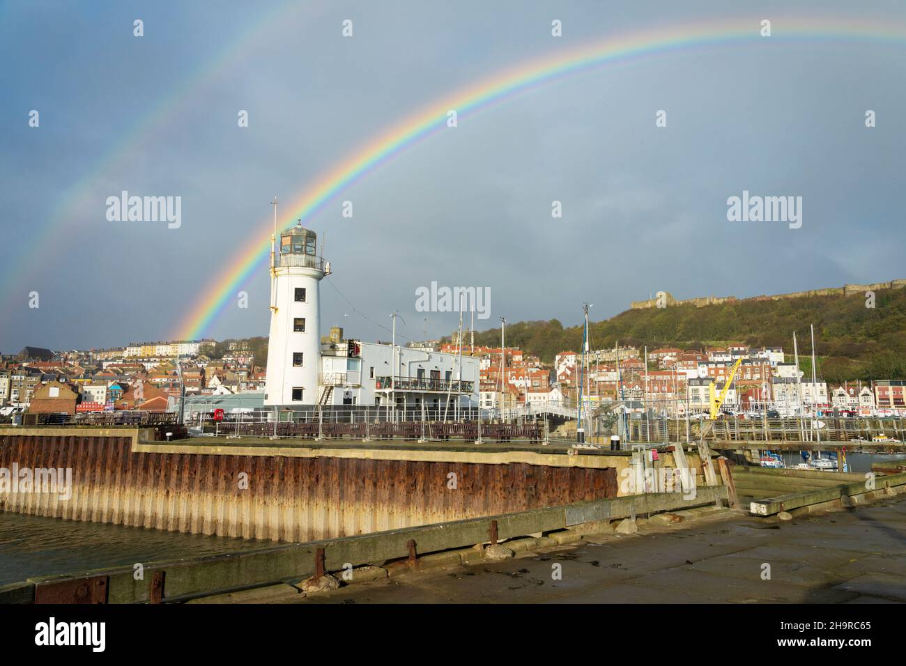 Autumn showers and a rainbow over Scarborough harbour, North Yorkshire UK Stock Photo
