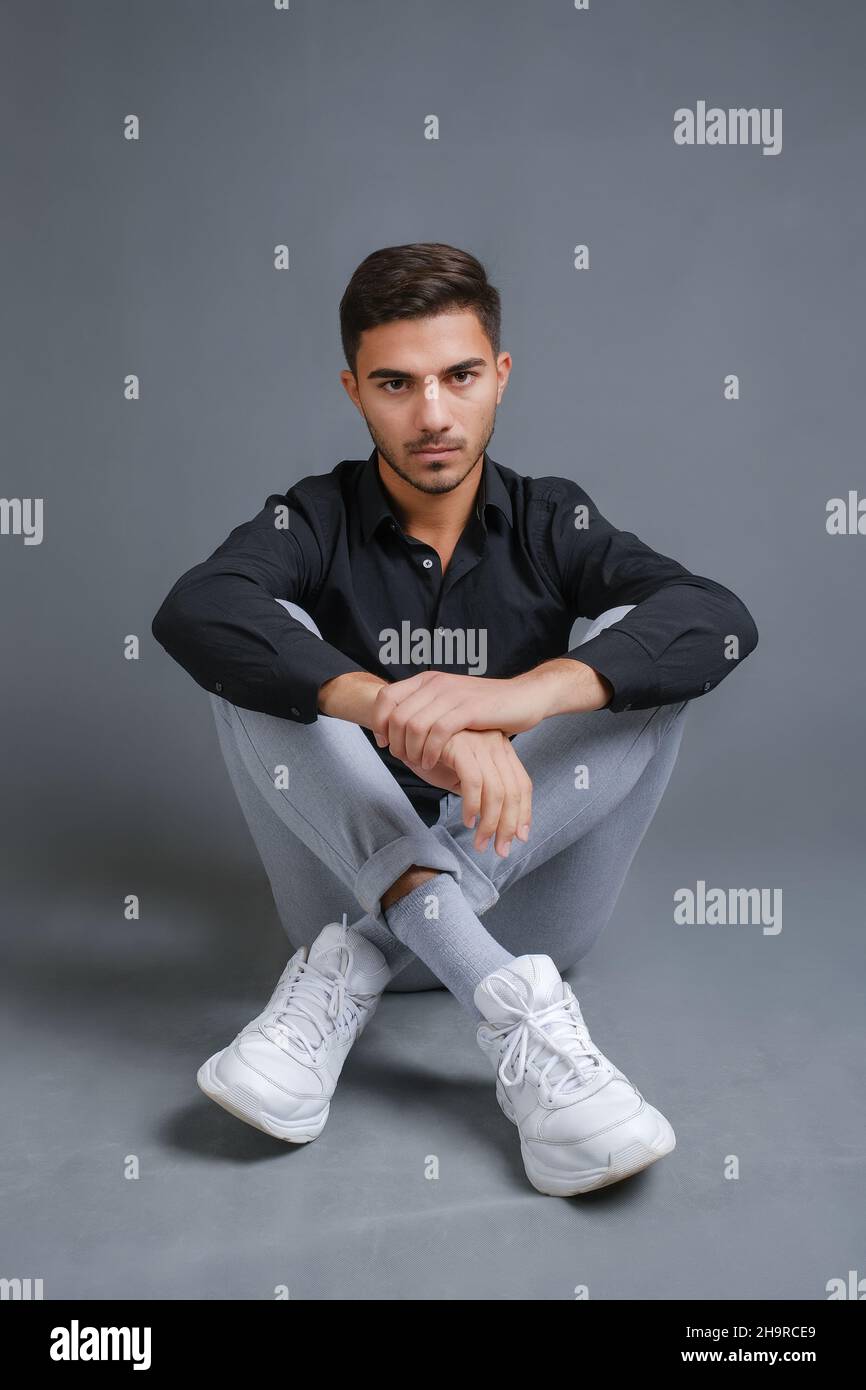 Full length portrait of confident young man in black shirt Stock Photo ...