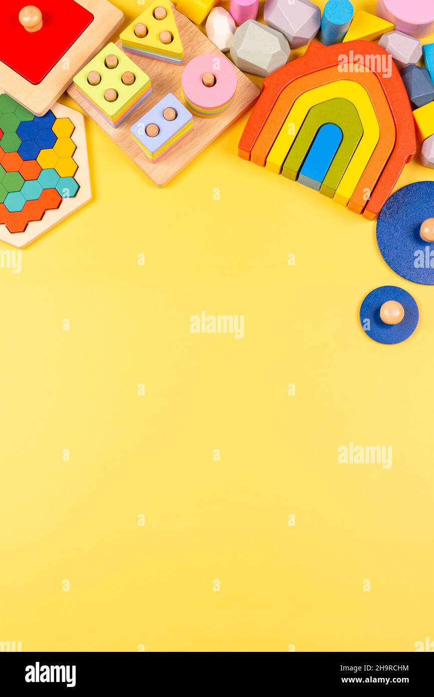 Baby kids toy frame. Educational wooden toys for children on yellow