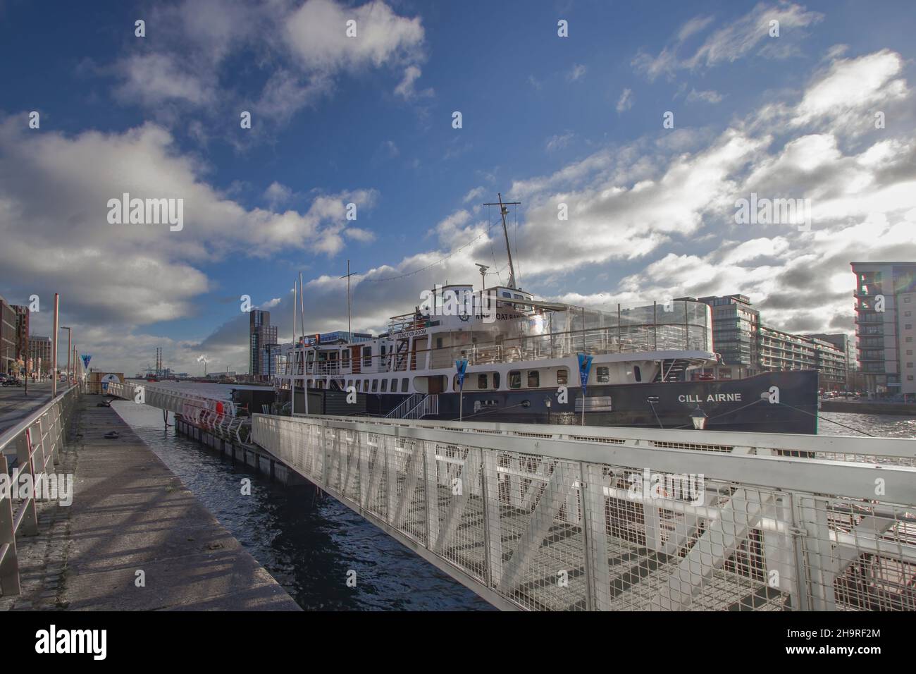 Cill Airne boat at Custom House Quay harbor wharf in Dublin Docklands in sunny beautiful day with blue spectacular sky above, urban and streets photog Stock Photo