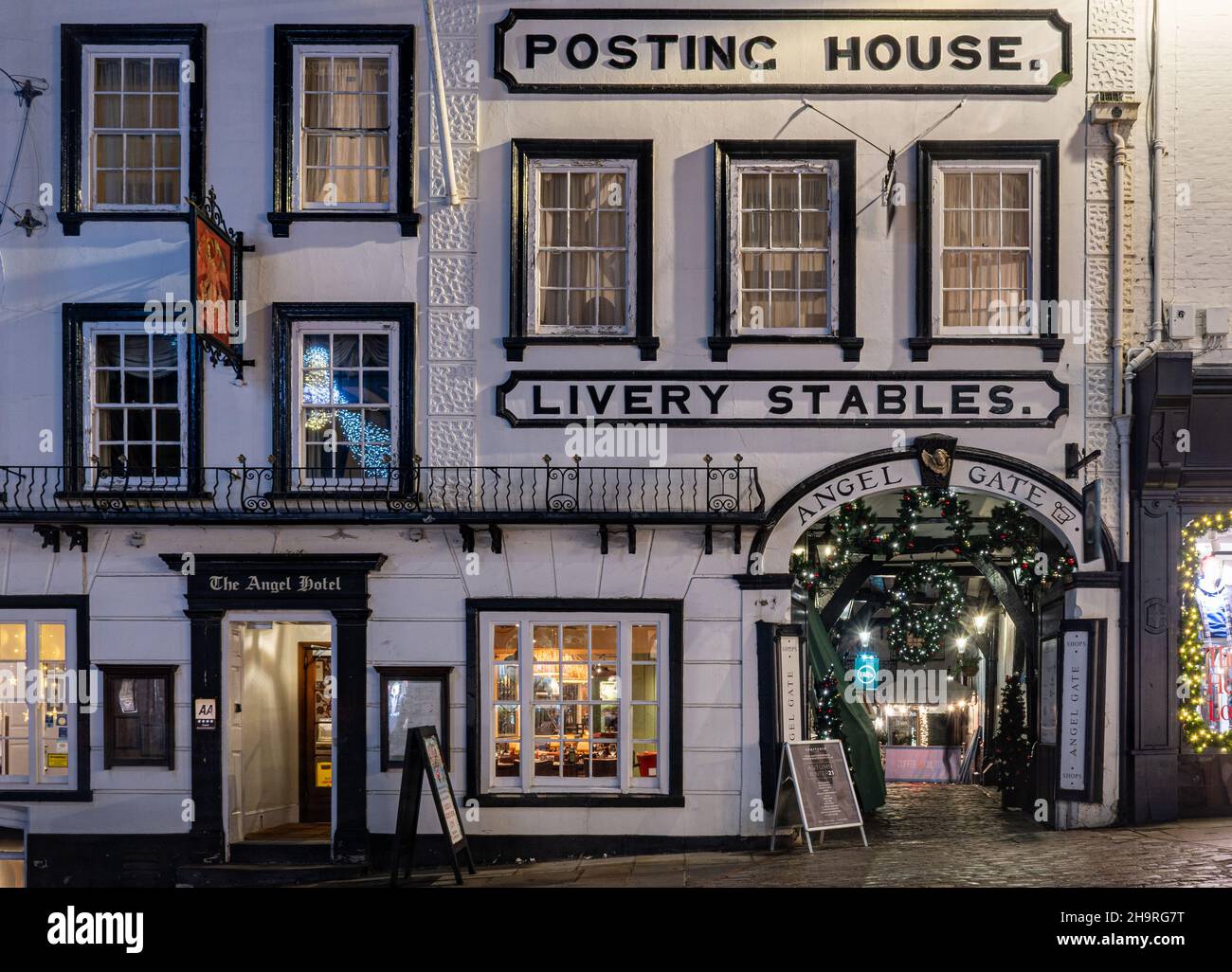 The Angel Hotel, former posting house livery stables, historic building on Guildford High Street decorated at Christmas, Surrey UK, with Angel Gate Stock Photo