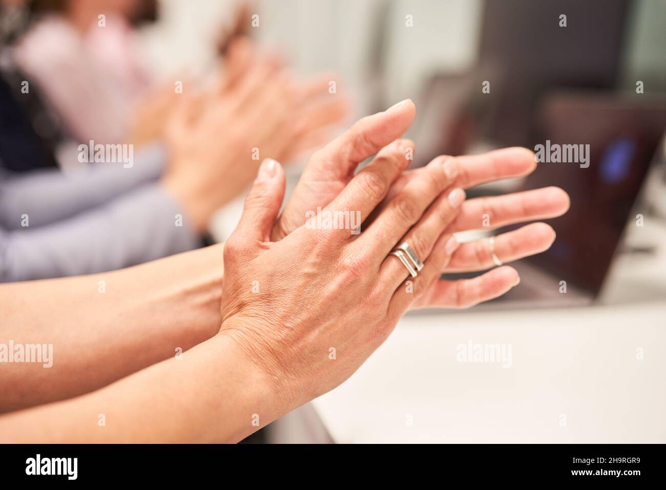 Group of people in the office giving applause and clapping hands as a sign of approval and appreciation Stock Photo