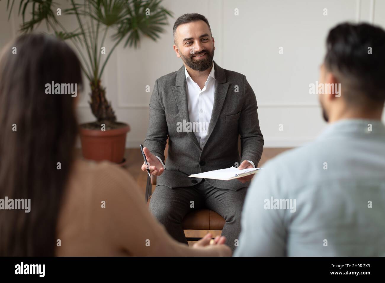 Young couple sitting at therapy session with therapist Stock Photo
