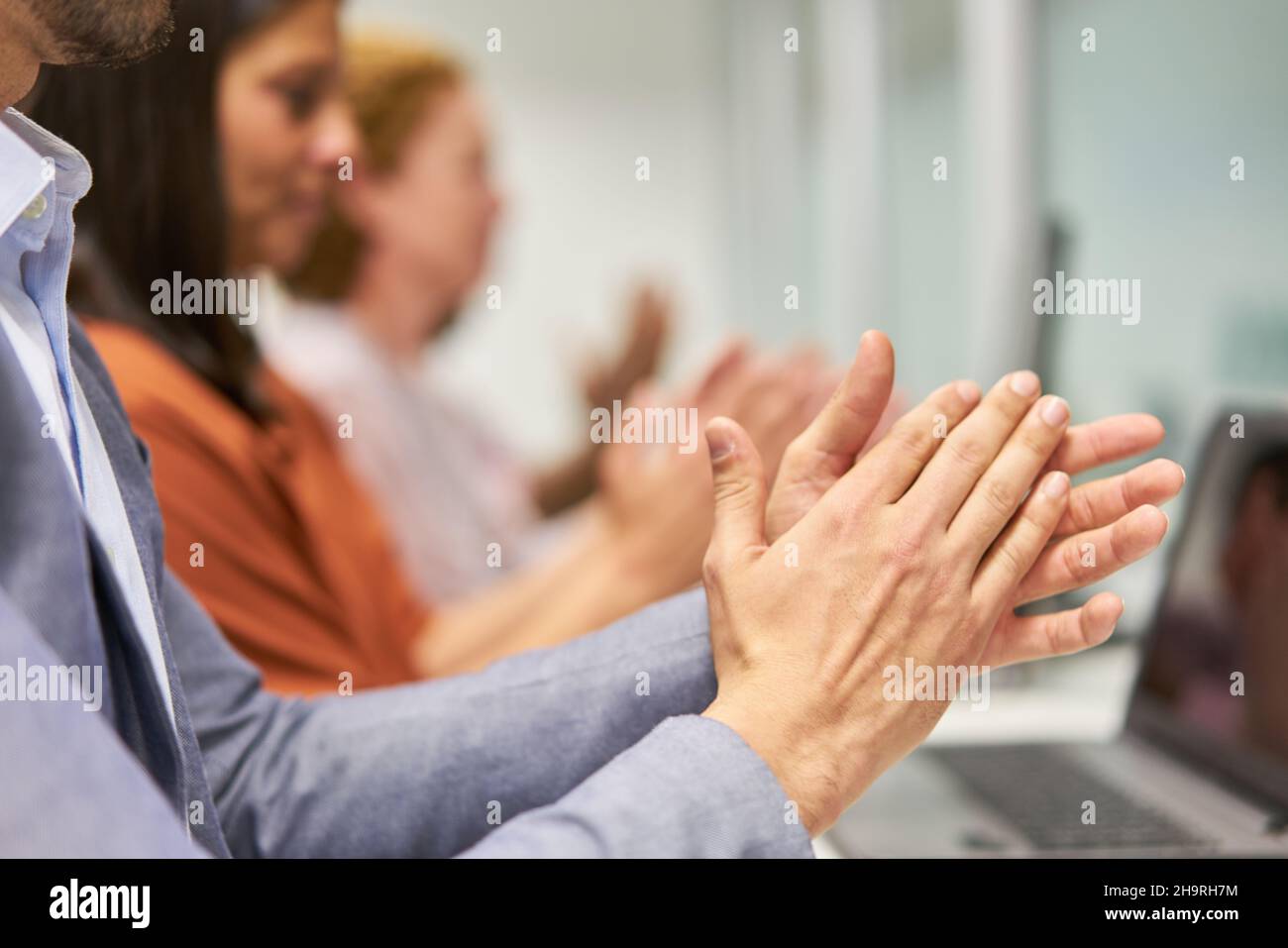 Business workshop participants applaud as a symbol of praise and recognition Stock Photo