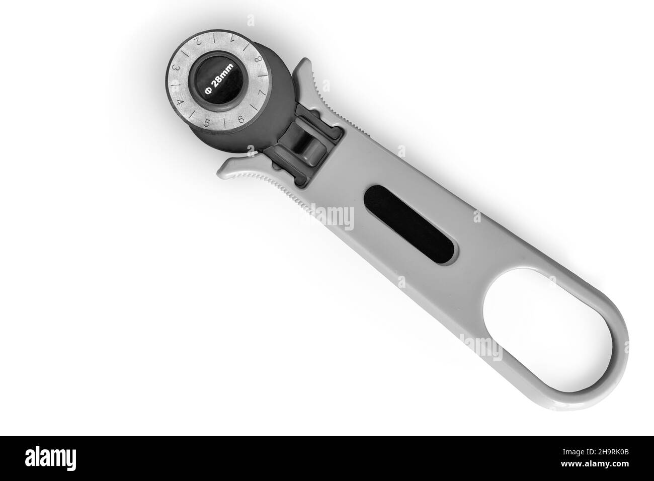 Sewing equipment: a convenient manual disc knife for cutting fabrics. Top view on a white background. Copy Space Stock Photo