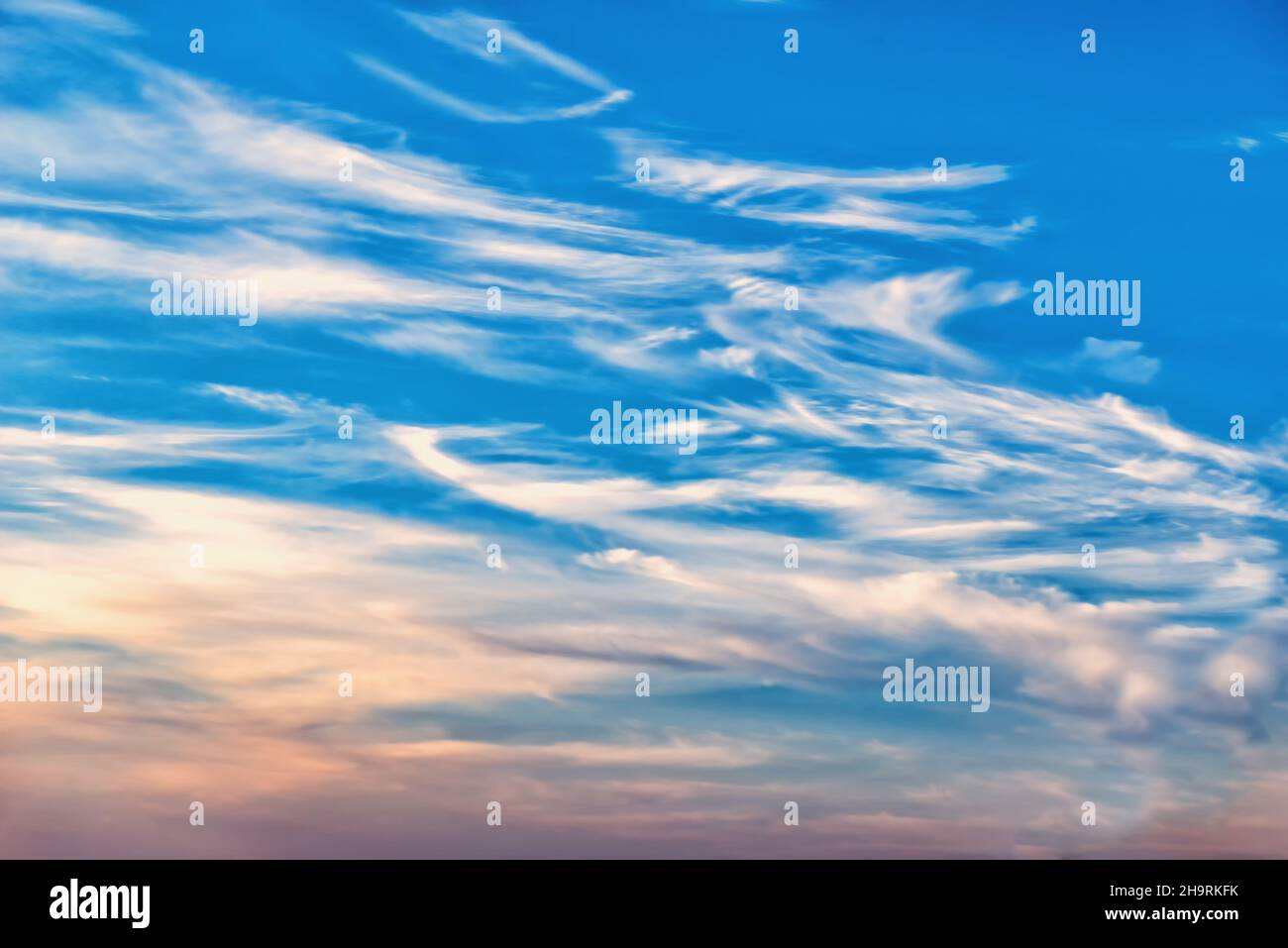 Celestial landscape of cirrus and cumulus clouds at dawn Stock Photo