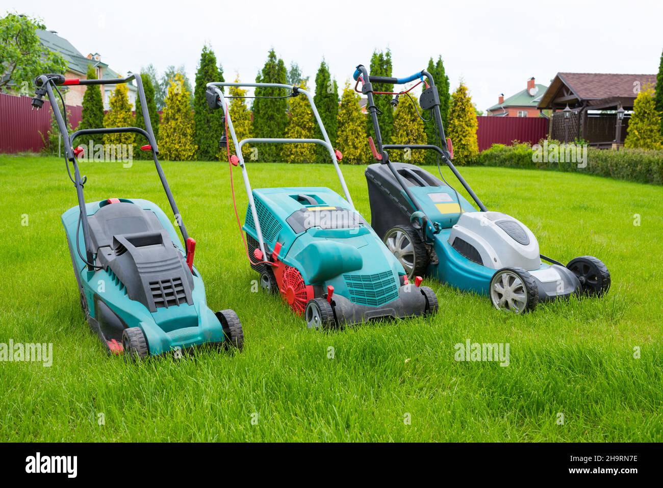 lawn mowers in the backyard. Gardening concept. Grass care. Stock Photo