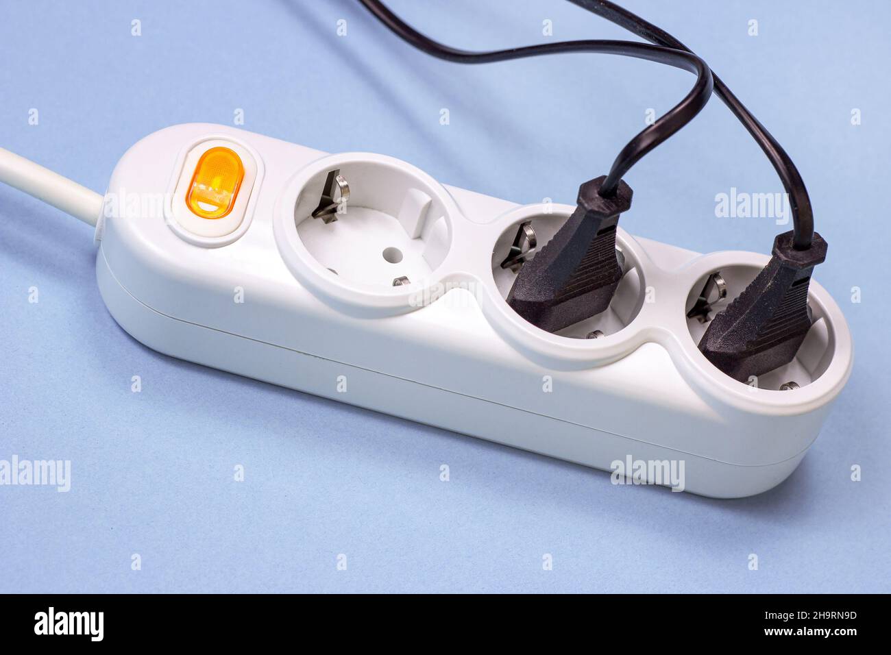 Triple socket white European power adapter with different wires at home