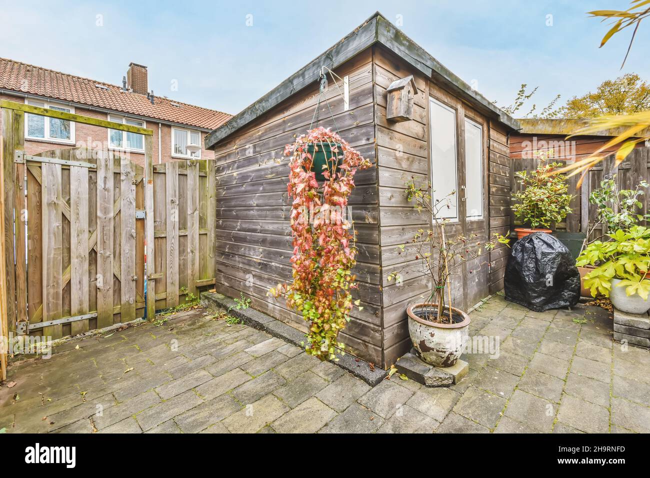 Cozy courtyard of a house with a wooden gate Stock Photo - Alamy