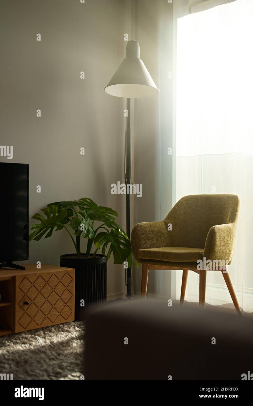 Armchair with lamp in morning. Scandinavian interior Stock Photo - Alamy