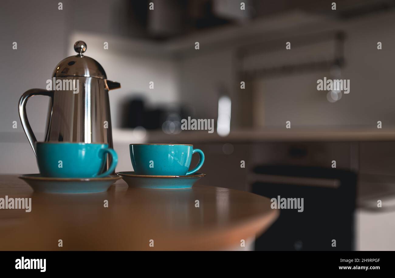 Teapot and two cups on the table in the morning. Stock Photo
