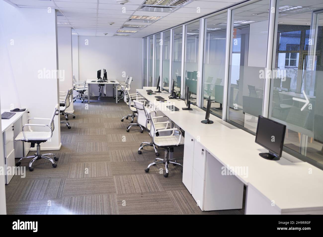 Open plan office with many computer workstations as coworking space Stock Photo