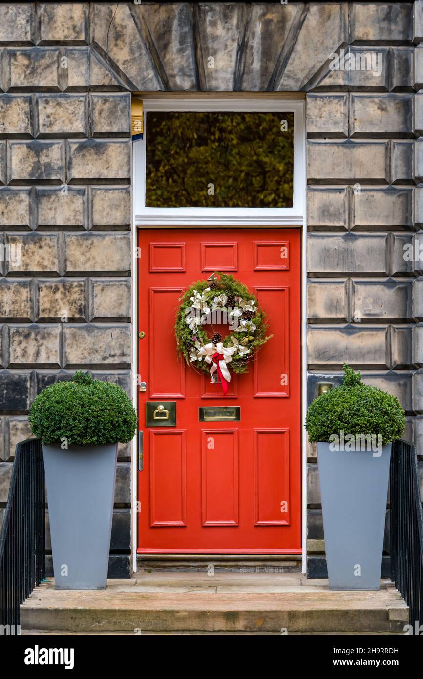 townhouse red painted front door with Christmas wreath