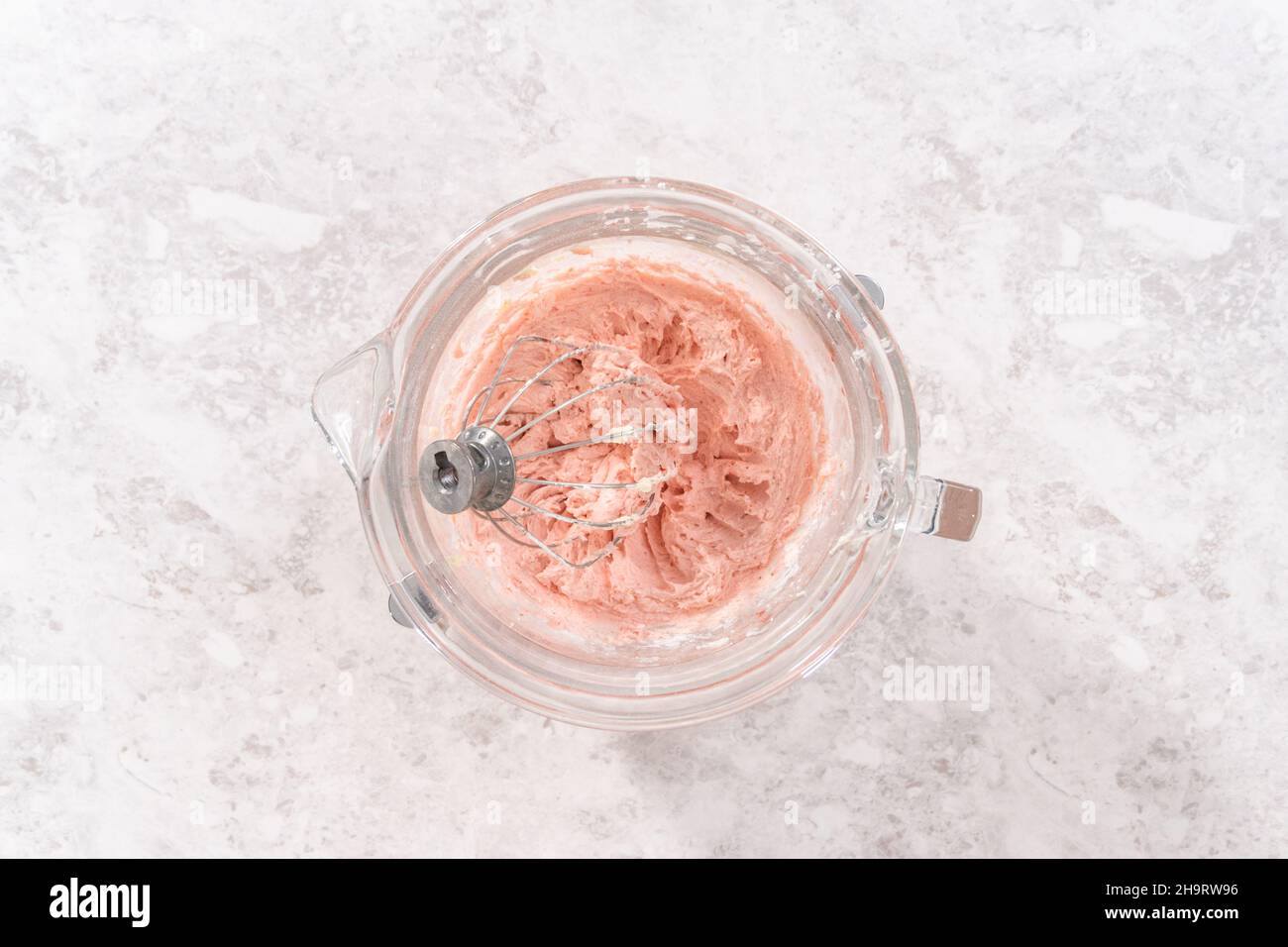 Flat lay. Whipping strawberry buttercream frosting in a standalone