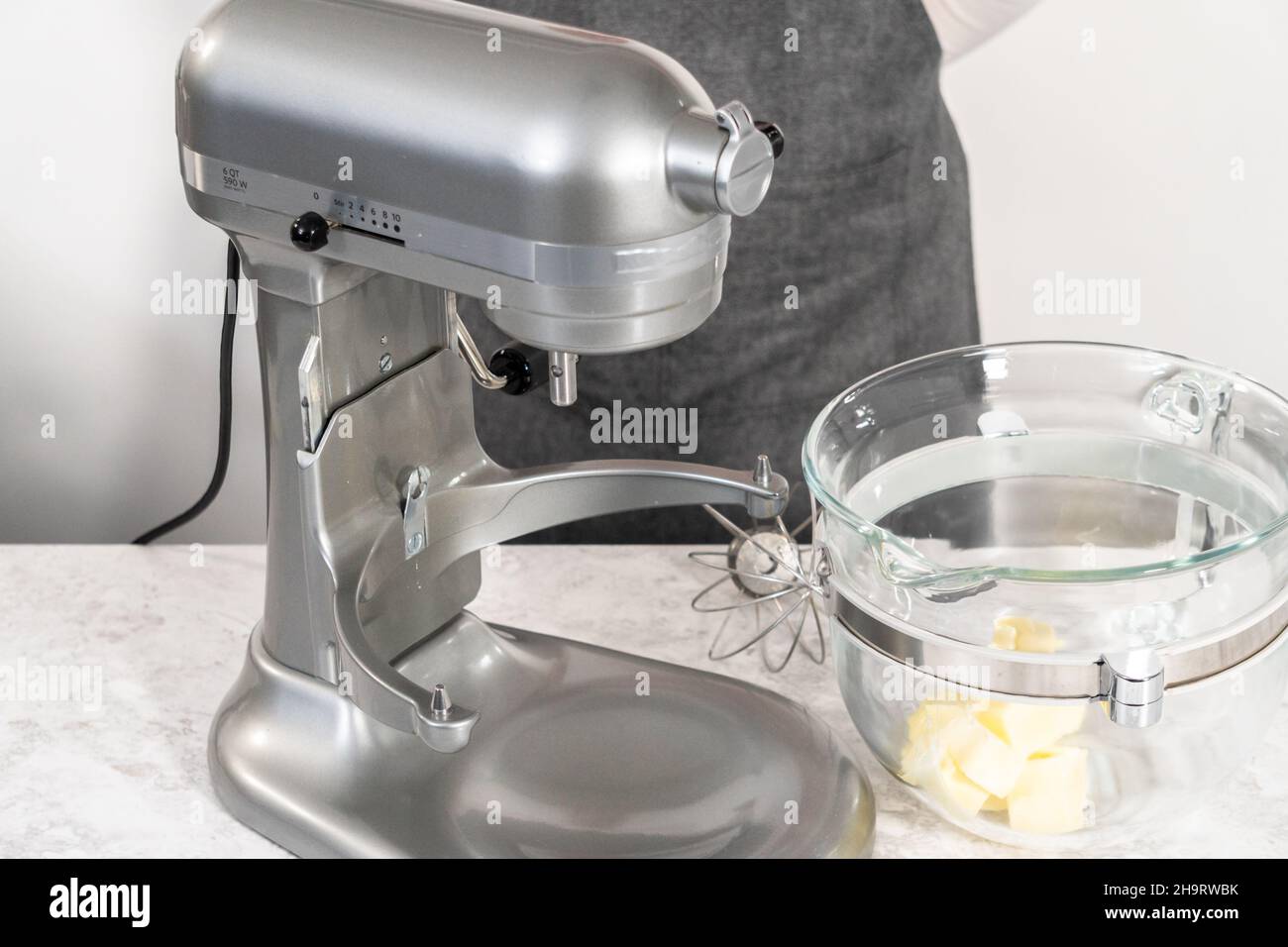 Whipping strawberry buttercream frosting in a standalone electric