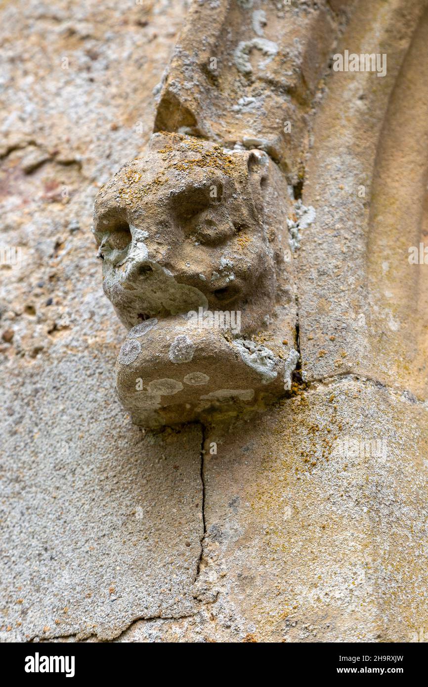 Church of All Saints, Frostenden, Suffolk, England, UK weathered carved stone face and head Stock Photo