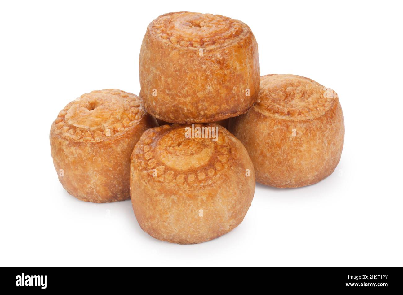 studio shot of small pork pies cut out against a white background - John Gollop Stock Photo