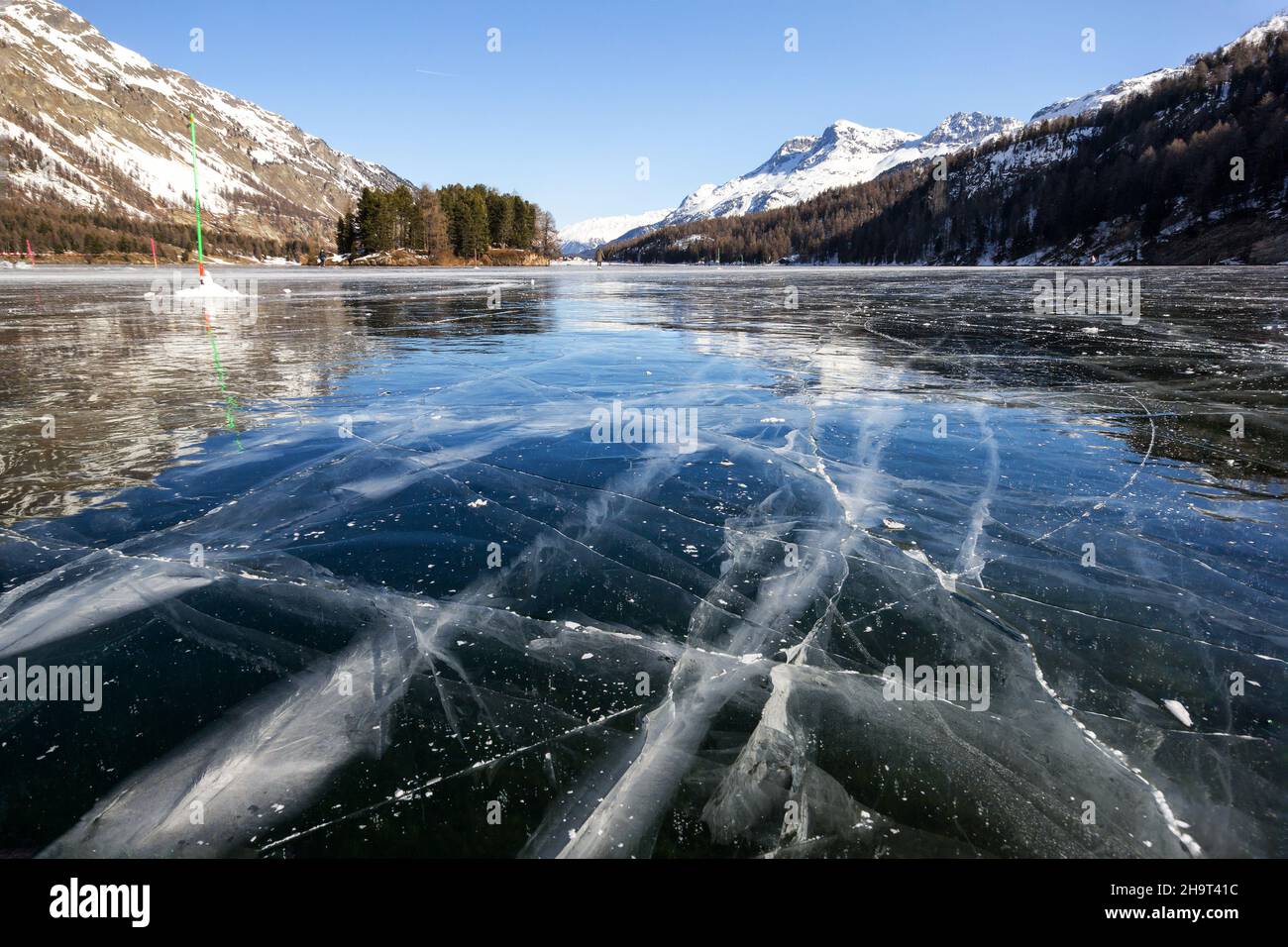 Cracks on the surface of the blue ice on frozen lake in winter ...
