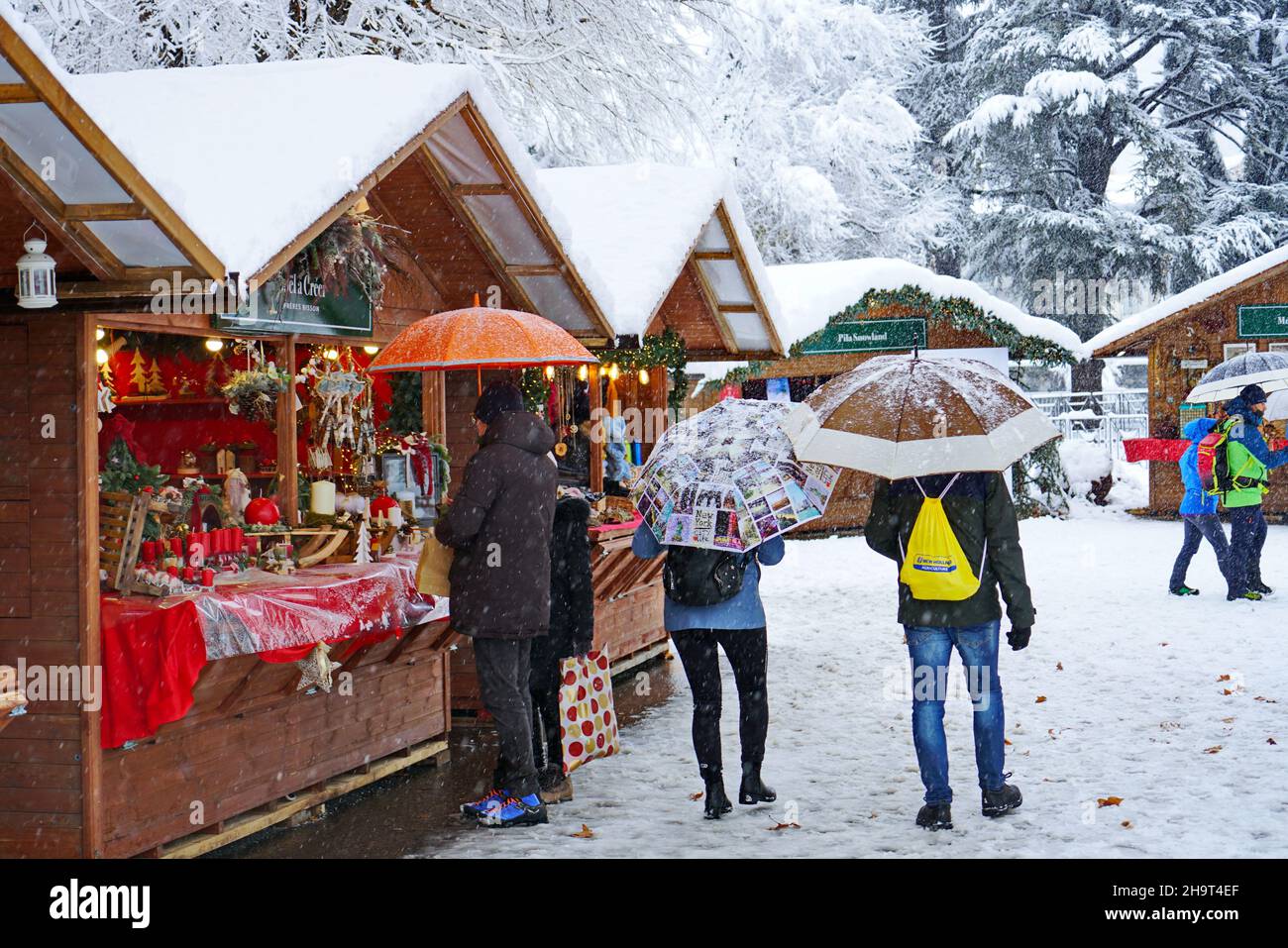 Traditional Christmas market under heavy snowfall. Aosta, Italy -December 2021 Stock Photo