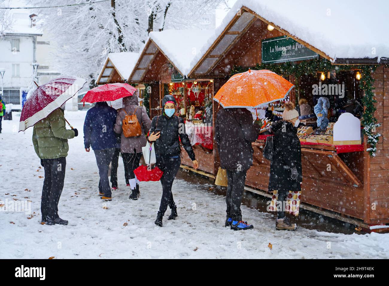 Traditional Christmas market under heavy snowfall. Aosta, Italy -December 2021 Stock Photo