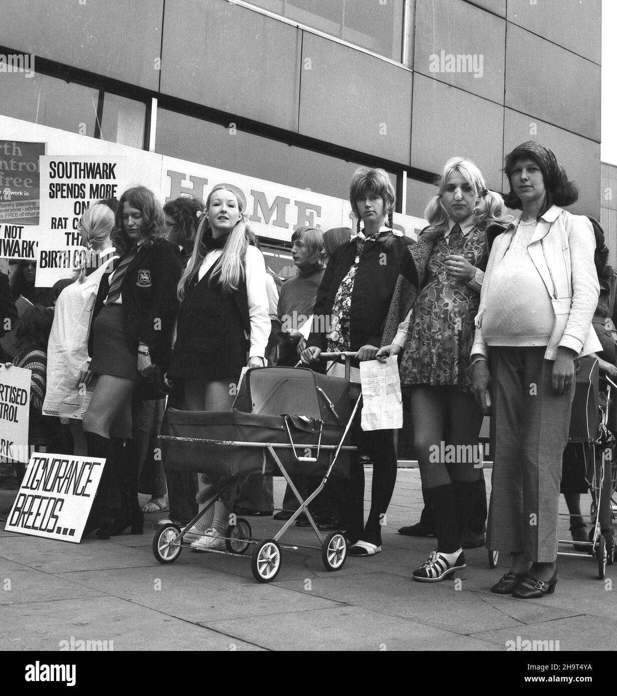 1970s, historical, group of people, with banners and placards, making a protest outside a shopping centre about the failure of Southwark Council, South London, to offer free birth control and contraception. A poster reads, 'Southwark Spends More on Rat Control Than Birth Control'. The ability of unmarried young  women to access contraception and prevent unwanted pregancies remained limited in parts of Britain until the end of the 1970s. Stock Photo