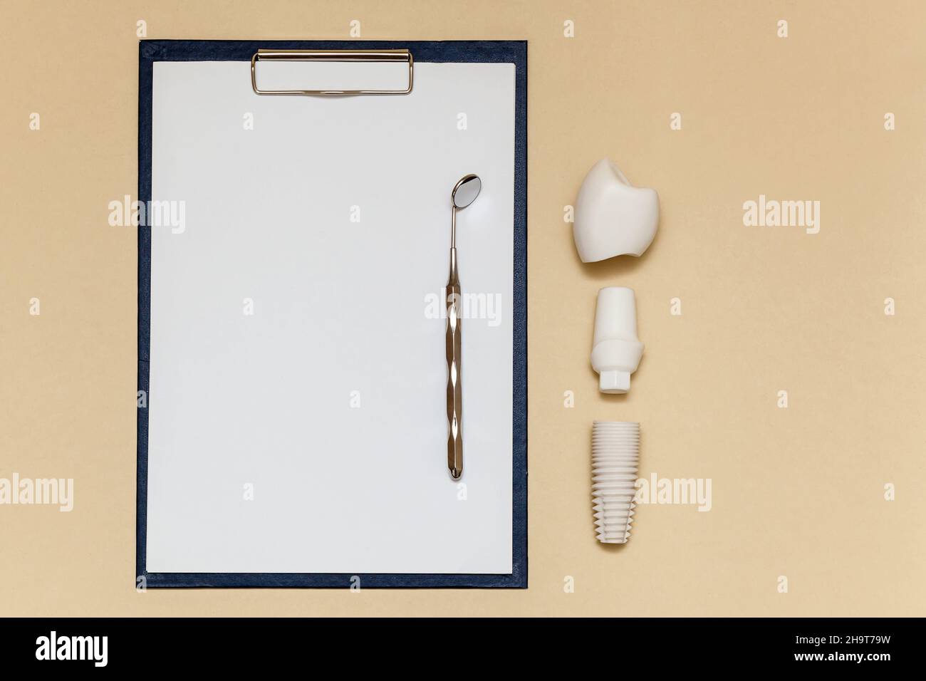 Dental implant and folder with clip for paper sheets A4 on beige
