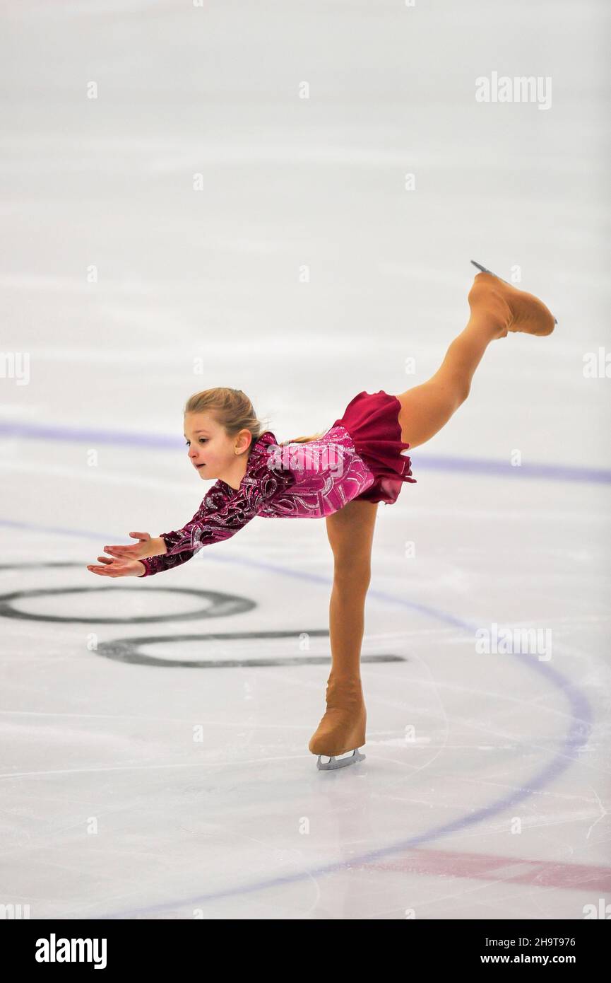 Little girl figure skater skating on ice indoor Stock Photo - Alamy