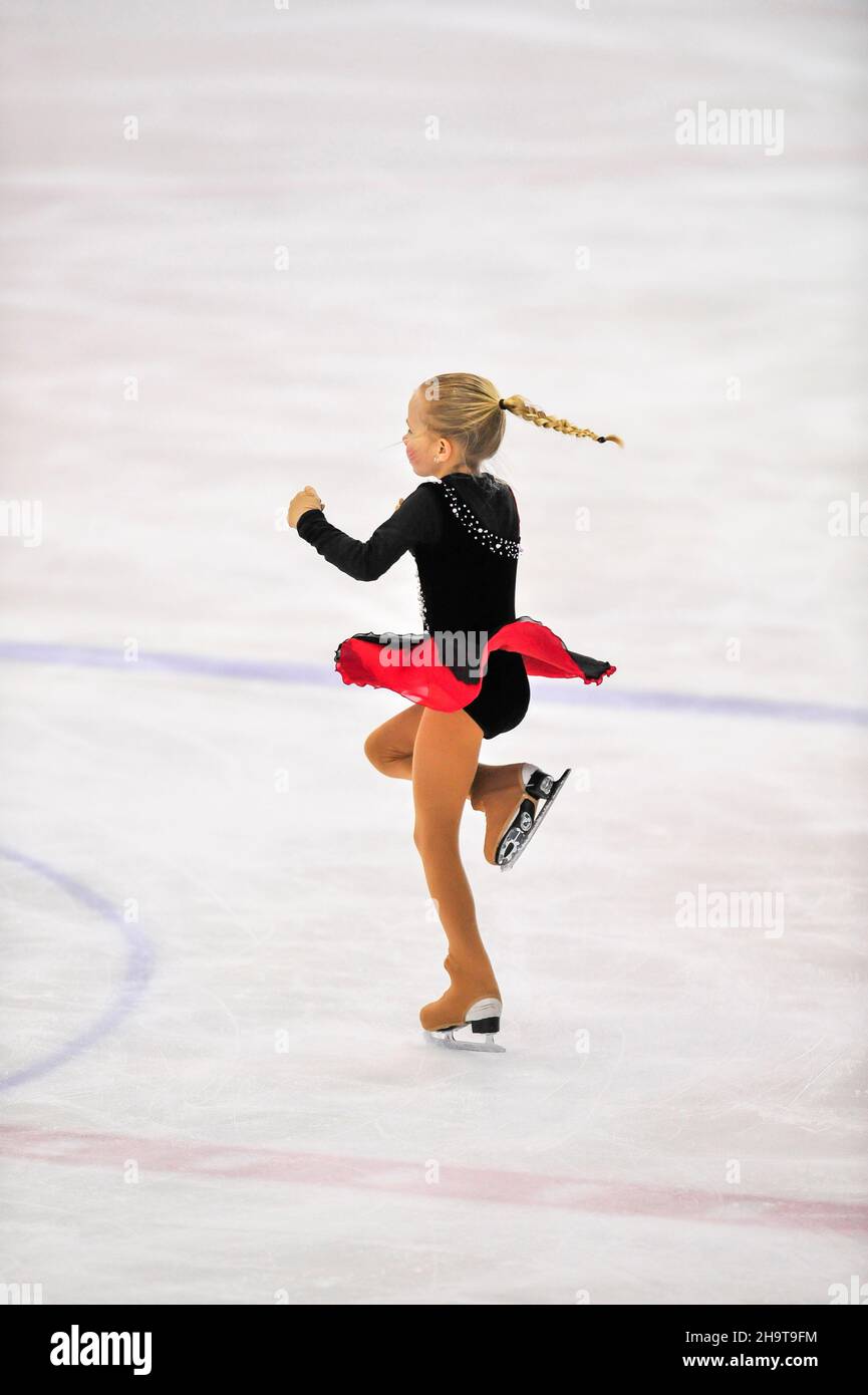 Little girl figure skater skating on ice indoor Stock Photo Alamy