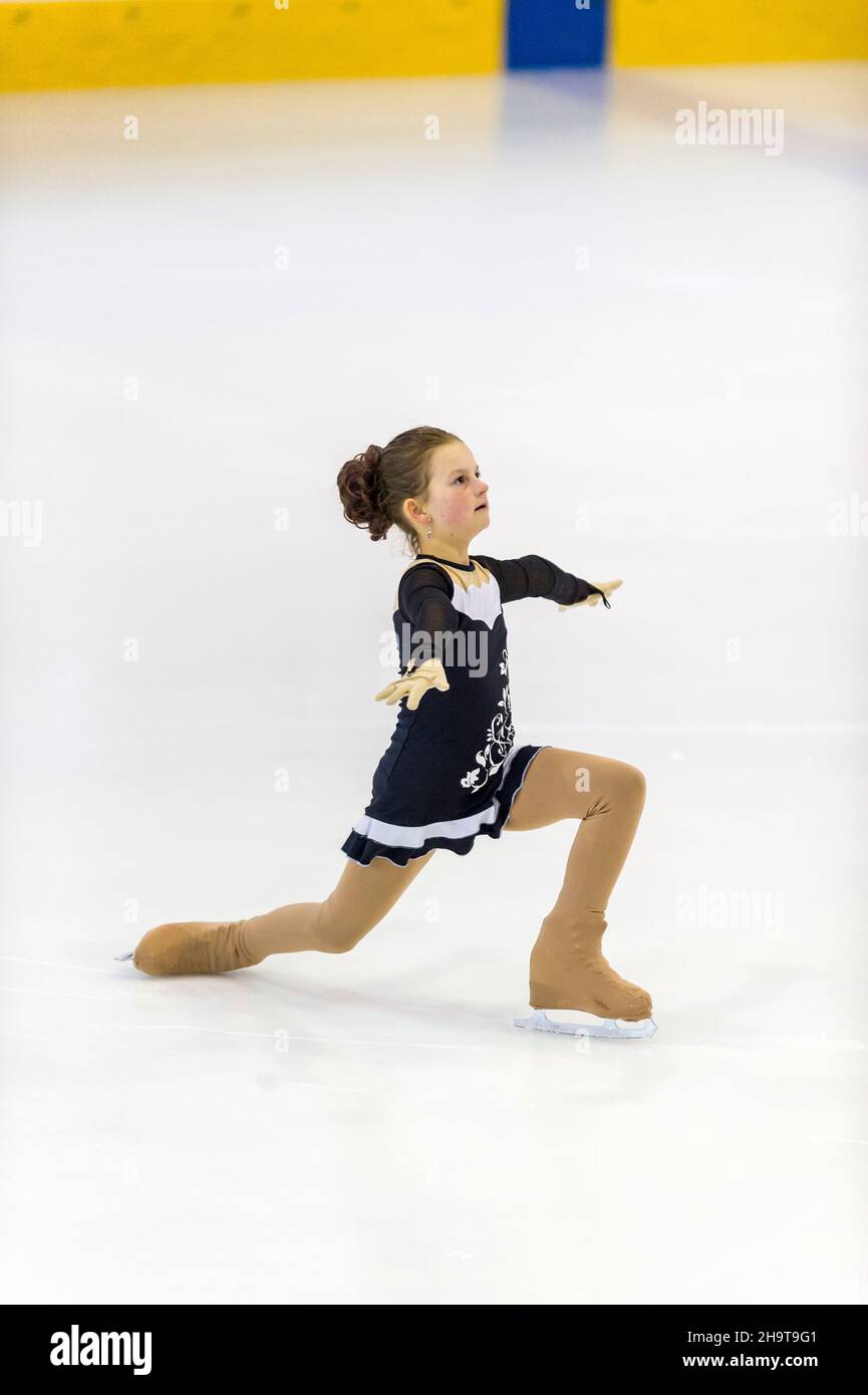Little girl figure skater skating on ice indoor Stock Photo Alamy