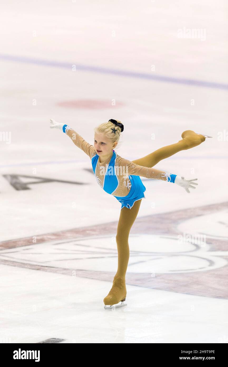 Little girl figure skater skating on ice indoor Stock Photo - Alamy