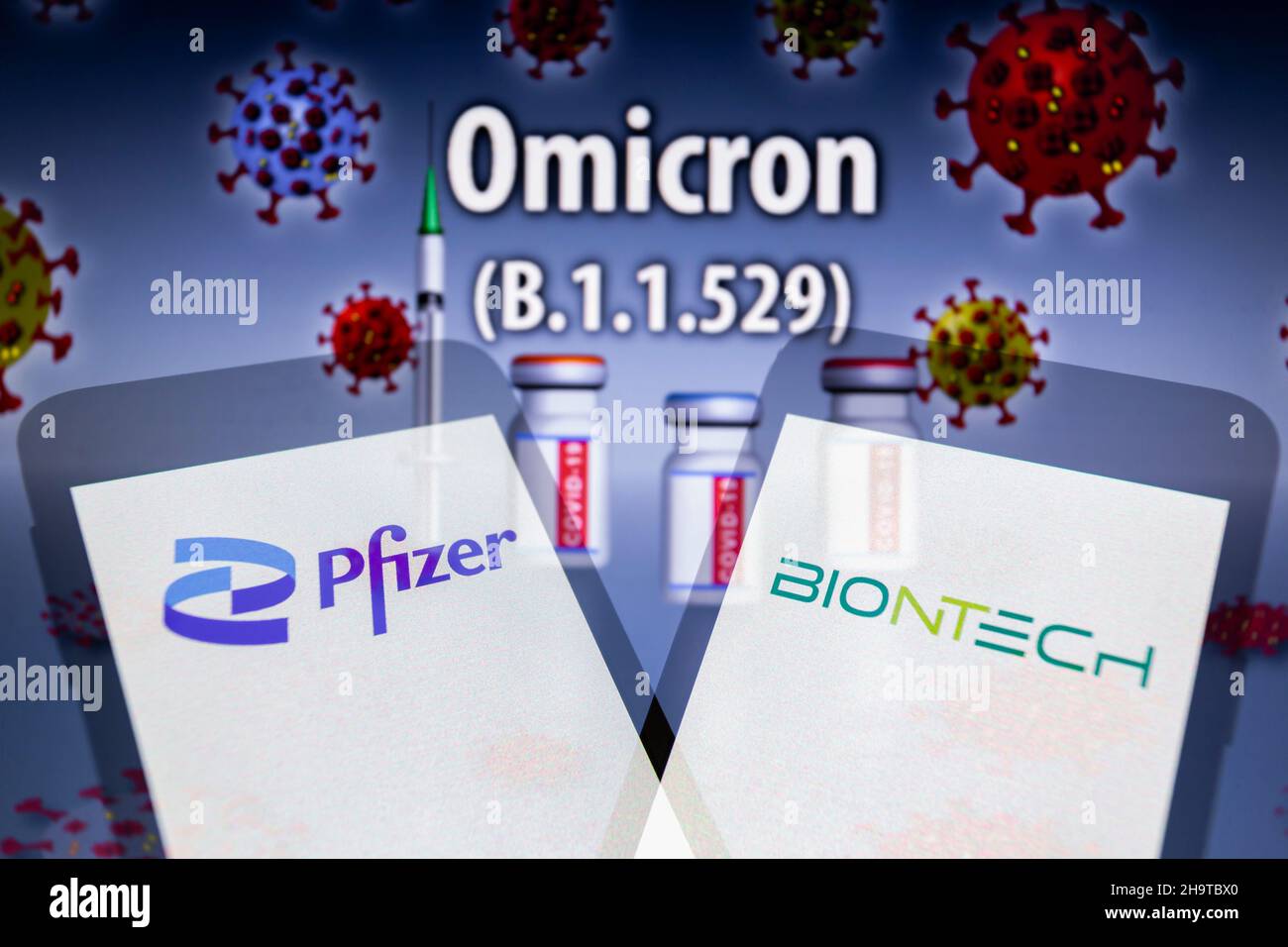 Asuncion, Paraguay. 8th Dec, 2021. Illustration: In-camera multiple exposure image shows logos of Pfizer and BioNTech on smartphone in front of the designation ''Omicron (B.1.1.529)'' and visual representation of virus, medical syringe and ampoules labeled COVID-19. Pfizer Inc. (NYSE: PFE) and BioNTech SE (Nasdaq: BNTX) today announced results from an initial laboratory study demonstrating that serum antibodies induced by the Pfizer-BioNTech COVID-19 vaccine (BNT162b2) neutralize the SARS-CoV-2 Omicron variant after three doses. (Credit Image: © Andre M. Chang/ZUMA Press Wire) Stock Photo