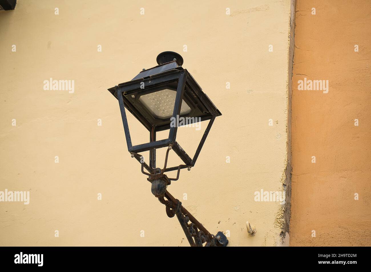 old lamppost on the facade of an old building, view Stock Photo