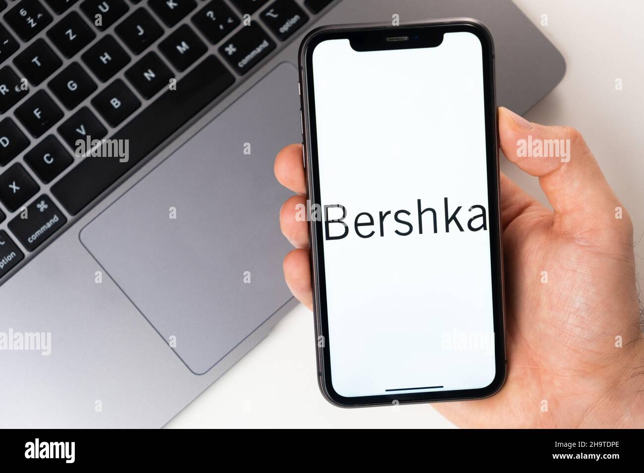 Bershka is a convenient mobile application for buying clothes, shoes and accessories online. A man is holding a smartphone with an open application in his hand. Online shopping November 2021, San Francisco, USA Stock Photo