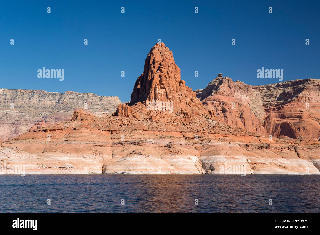 Glen Canyon National Recreation Area, Utah, USA. Majestic red sandstone butte towering above Lake Powell. Stock Photo