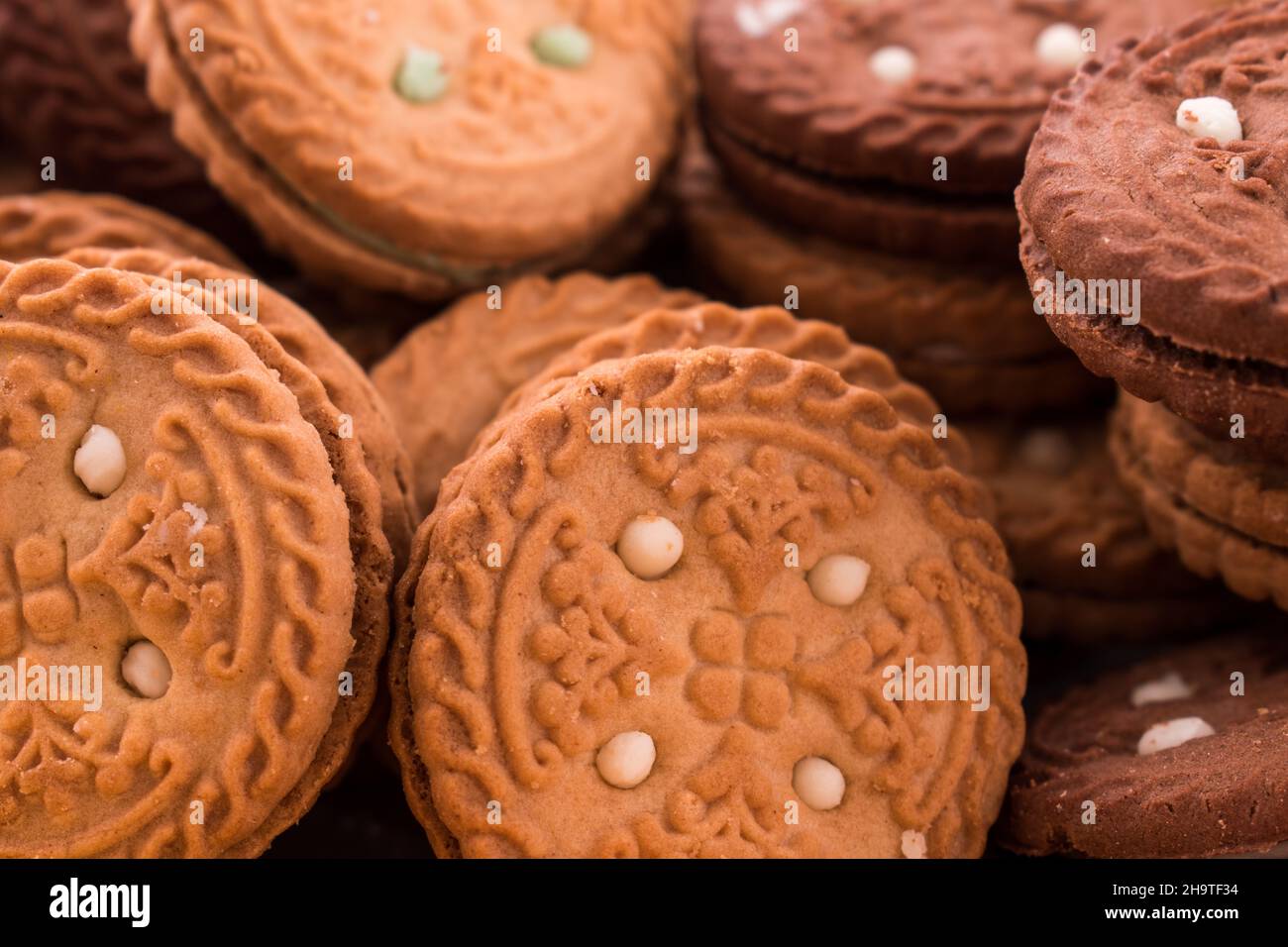 Some different cookies on a black wooden table Stock Photo
