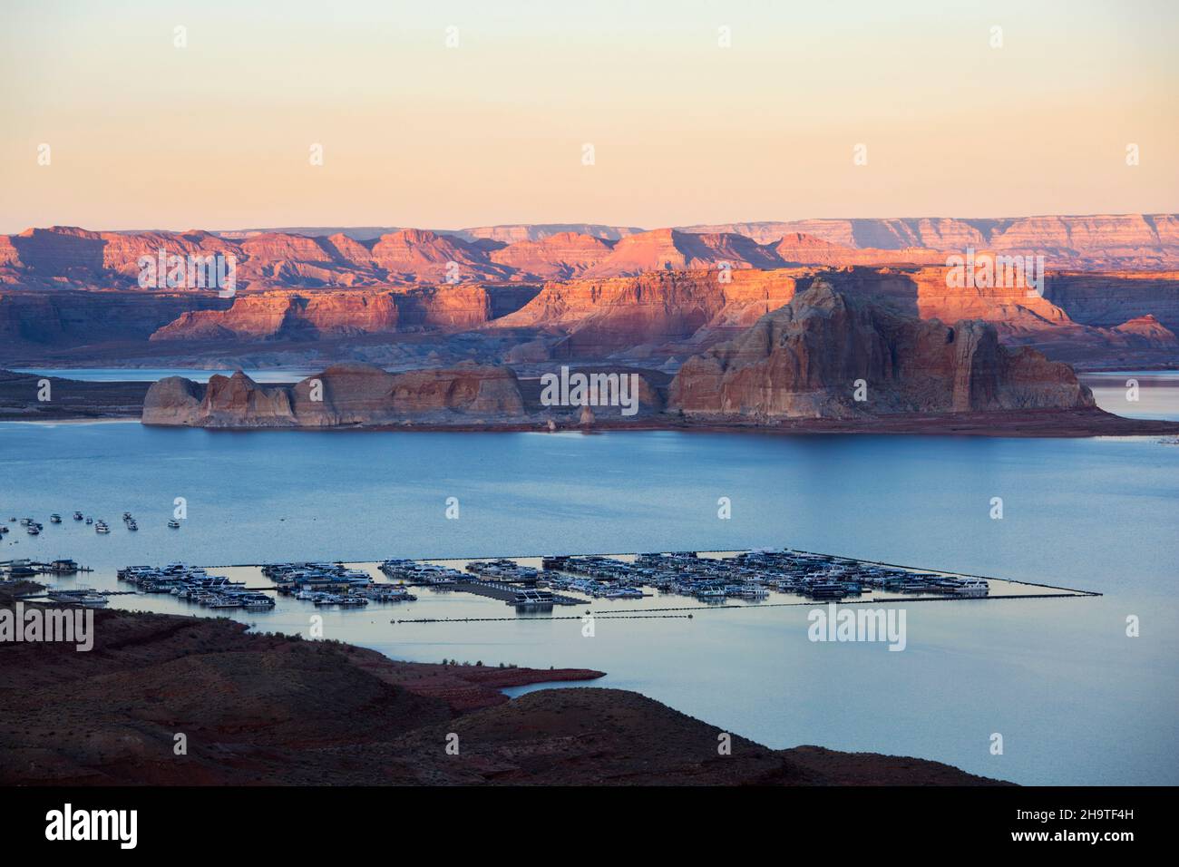 Glen Canyon National Recreation Area, Page, Arizona, USA. View over Wahweap Marina to the high rugged cliffs of Castle Rock and Romana Mesa, sunset. Stock Photo