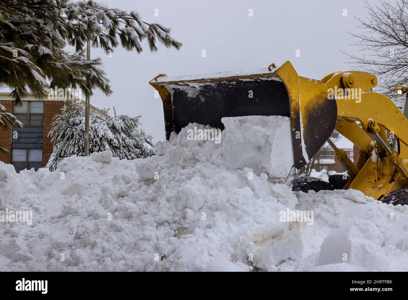 Municipal service with snowplow removing snow from road Stock Photo