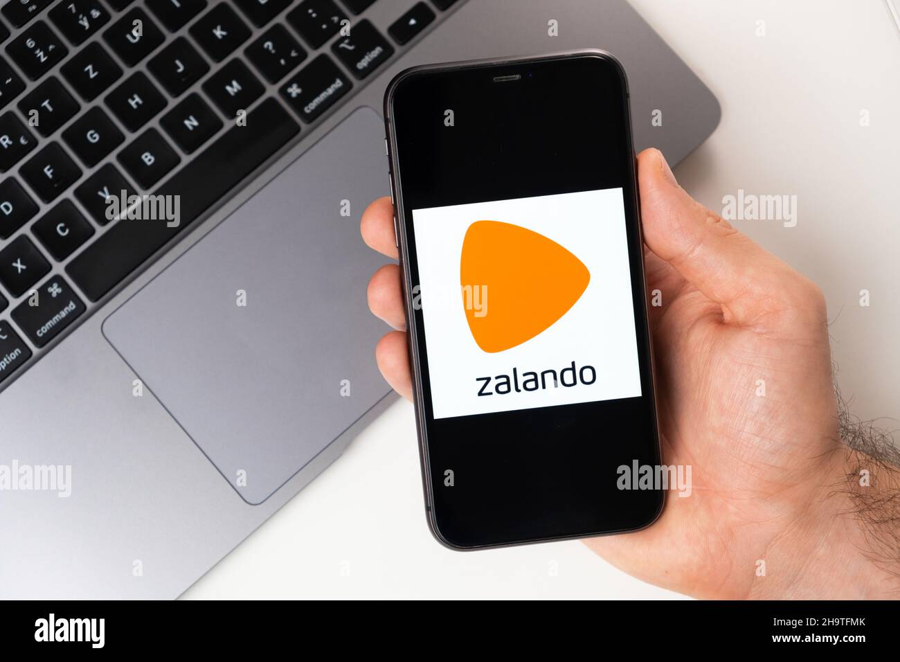 Zalando is a convenient mobile application for buying clothes, shoes and  accessories online. A man is holding a smartphone with an open application  in his hand. Online shopping November 2021, San Francisco,