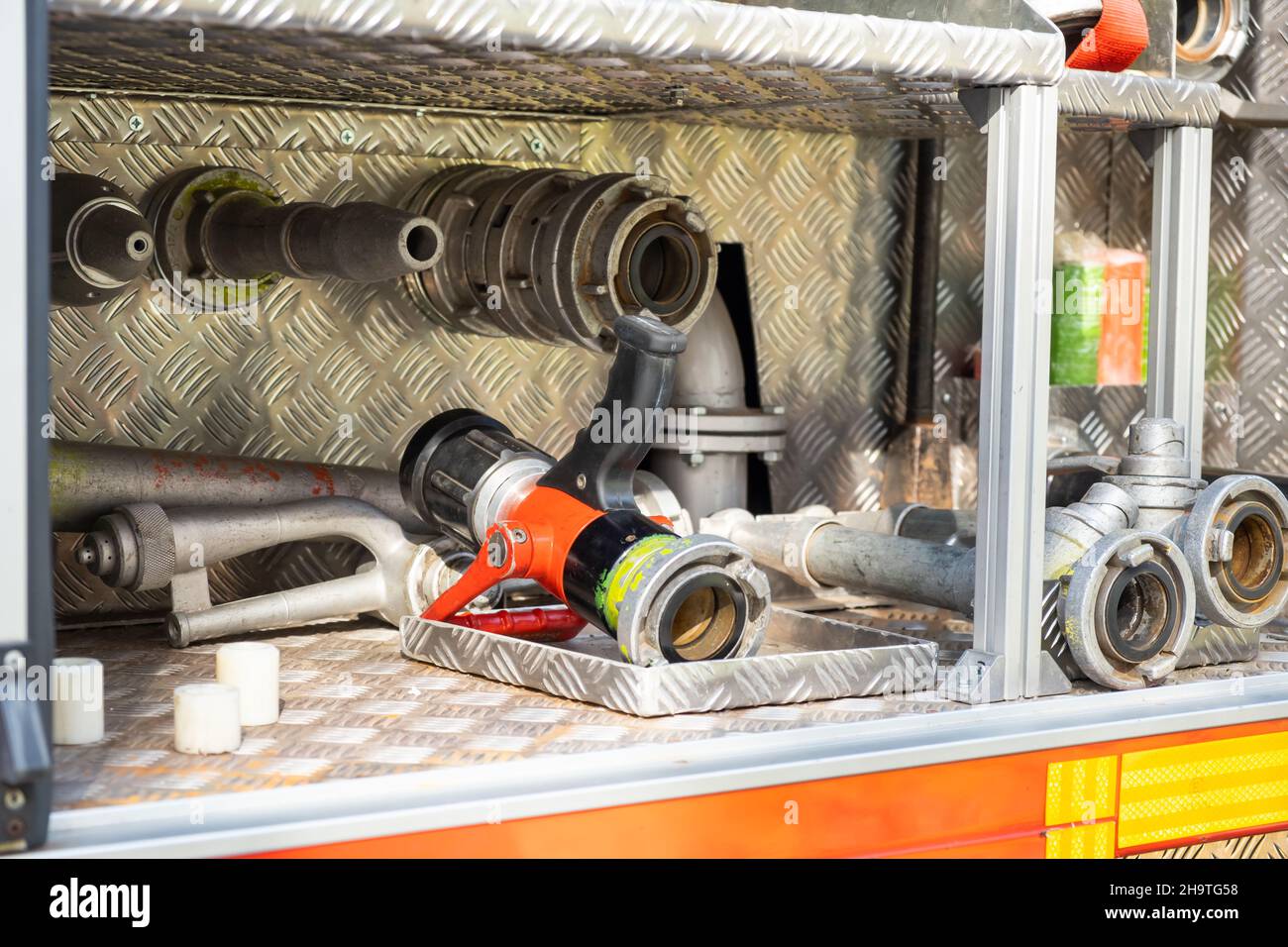 Different details of firefighting equipment ready to assemble in open truck metal body at contemporary station close view Stock Photo