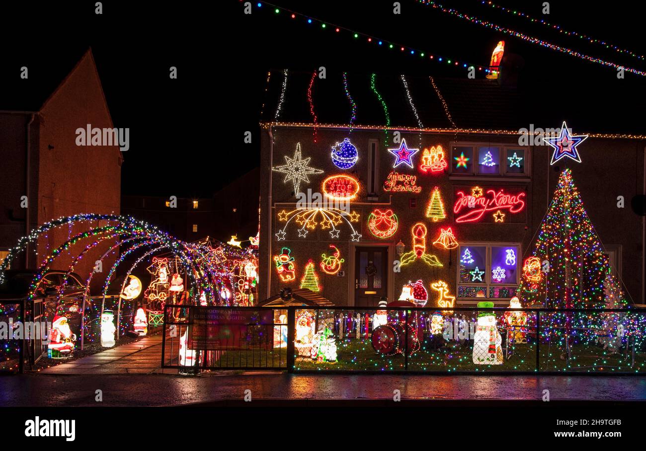 Prestonpans, East Lothian, Scotland, UK.  8th December 2021. Woods Family Christmas Lights, have survived two named storms this year as the family once again invite donations to raise money for Forth One's Cash For Kids campaign. The family decorate with over 20,000 individual led lights, a 16ft 'mega tree', inflatable snowmen, and many more colourful decorations. They encourage people from all over the lothians to bring their children to see and enjoy the lighting spectacle. Credit: Arch White/ Stock Photo