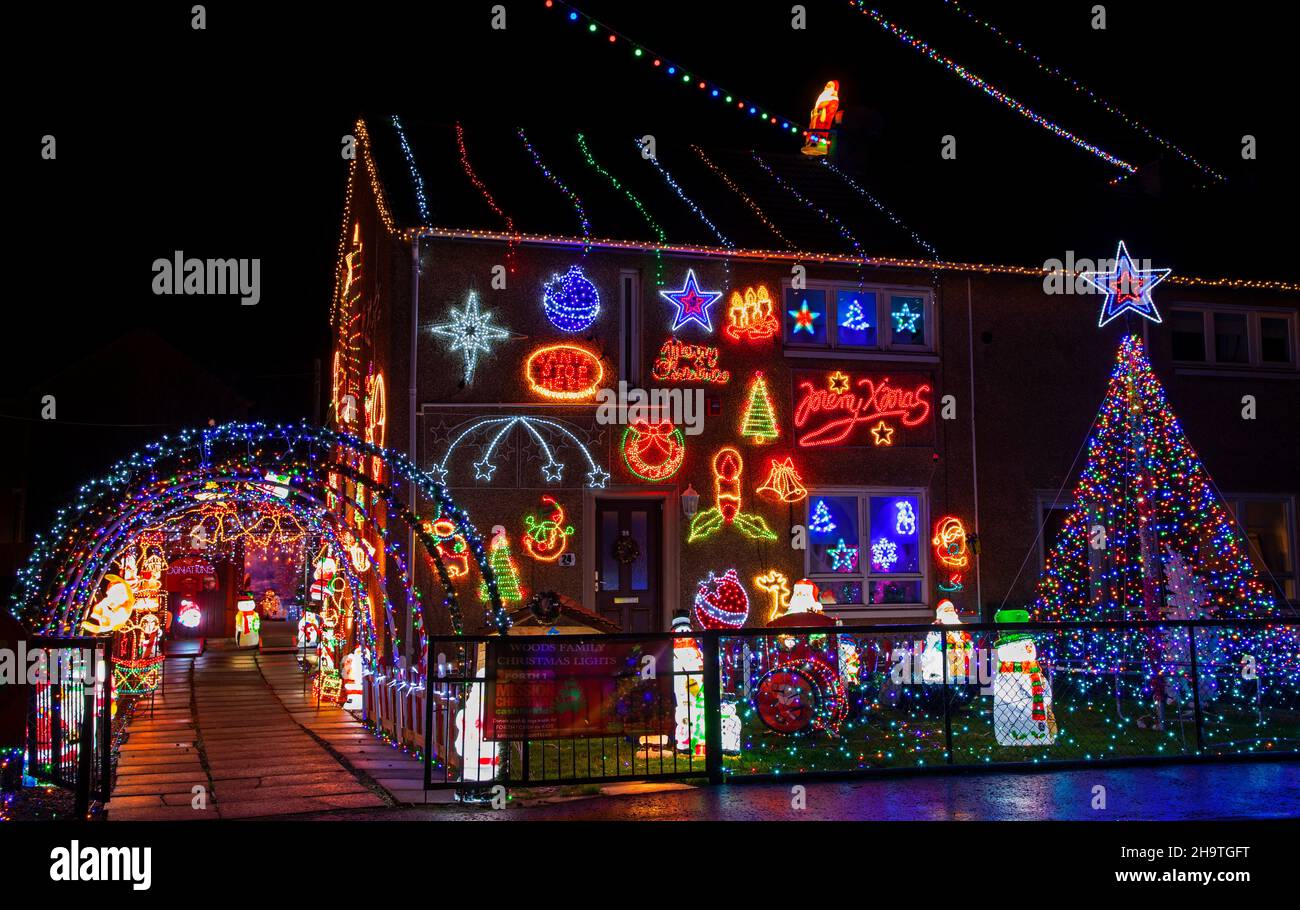 Prestonpans, East Lothian, Scotland, UK.  8th December 2021. Woods Family Christmas Lights, have survived two named storms this year as the family once again invite donations to raise money for Forth One's Cash For Kids campaign. The family decorate with over 20,000 individual led lights, a 16ft 'mega tree', inflatable snowmen, and many more colourful decorations. They encourage people from all over the lothians to bring their children to see and enjoy the lighting spectacle. Credit: Arch White/ Stock Photo