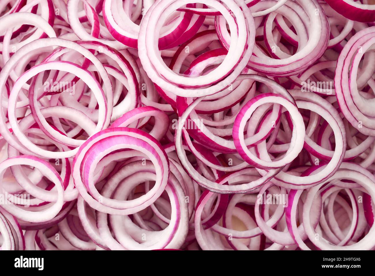 Onion rings as a background. Top view Stock Photo - Alamy