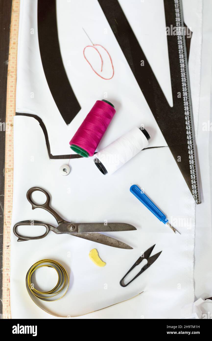 Dressmaker's work tools on a table. Scissors, meter, threads and rulers Stock Photo Alamy