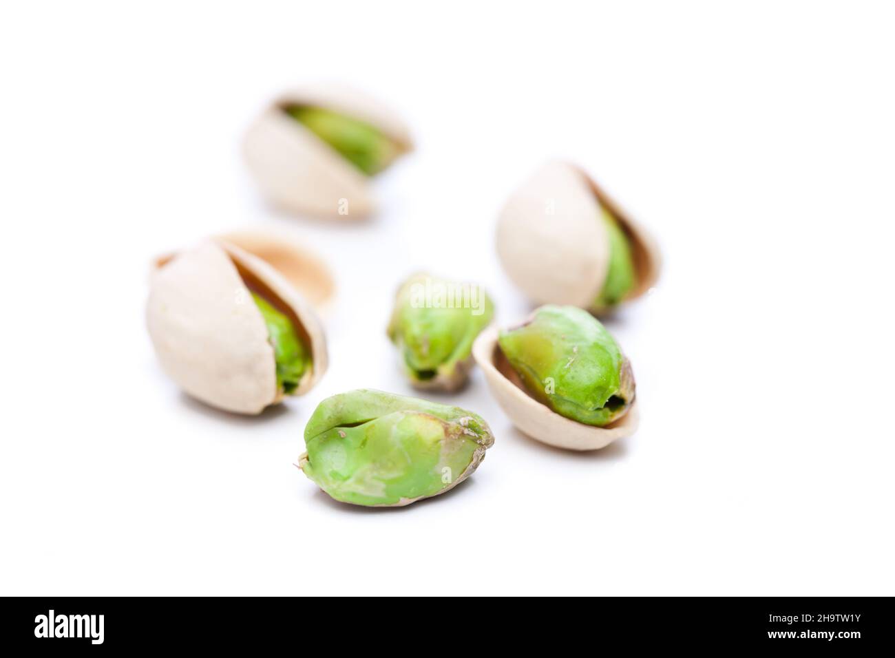 pistachio, pistachios, shell, shells, pistachio nuts, some, open, salted, green, white, background, close, closeup, close-up, many, lying, peeled, ins Stock Photo