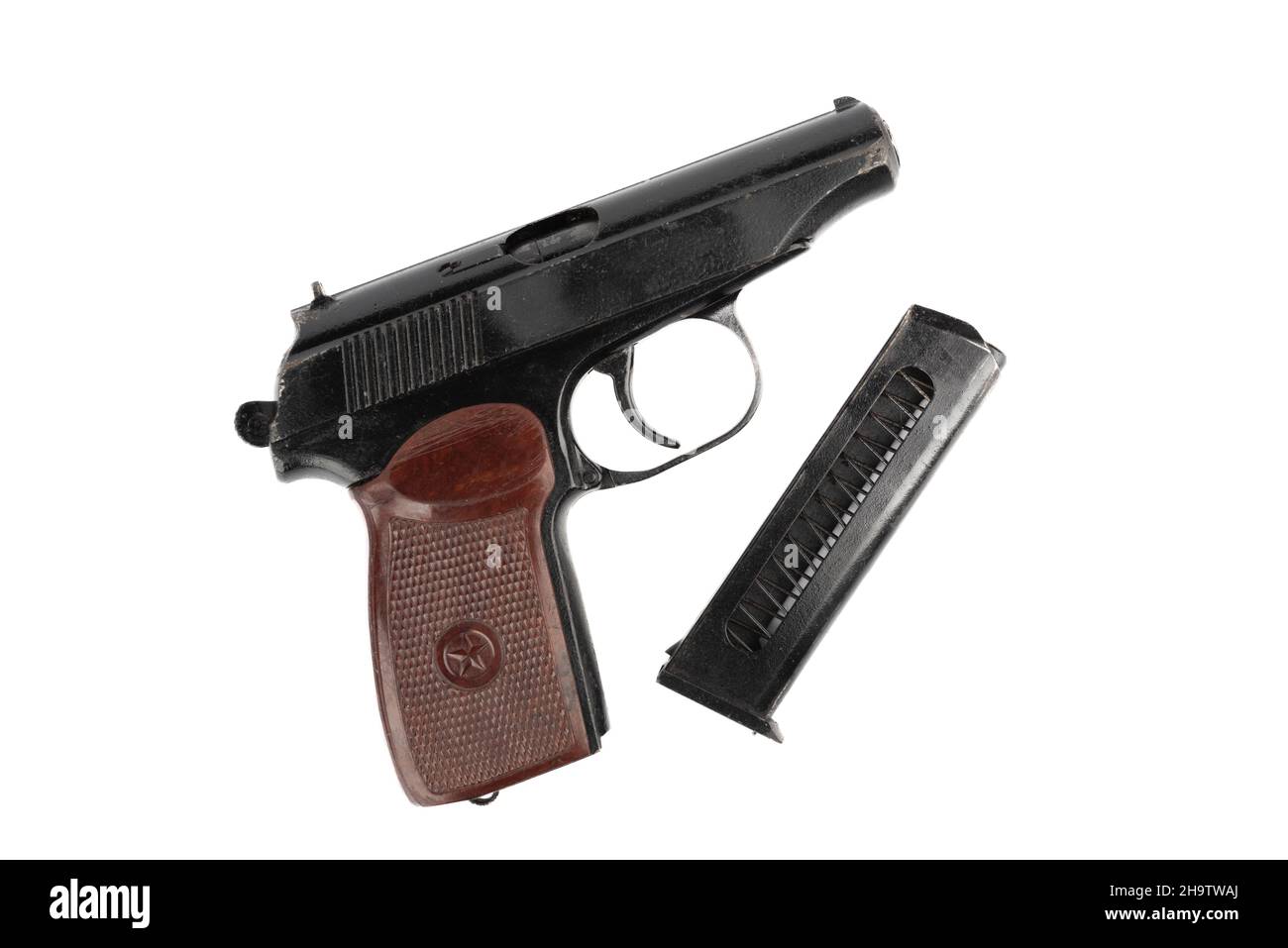 Top view of a Makarov pistol and a separate magazine for cartridges. Makarov pistol on a white background. Stock Photo