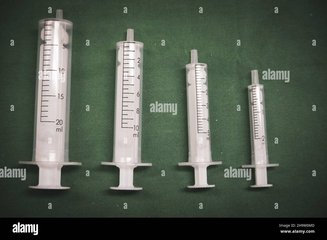different size medical syringes stand next to each other Stock Photo