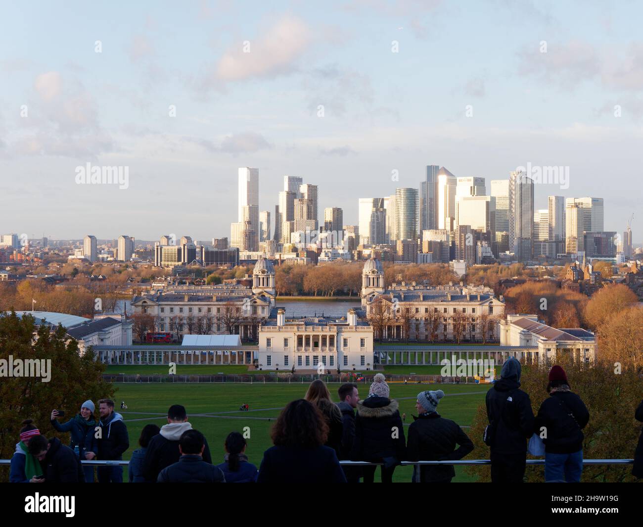 London, Greater London, England, December 04 2021: Tourists enjoying the view from the hill in Greenwich Park towards Queens House and the University, Stock Photo