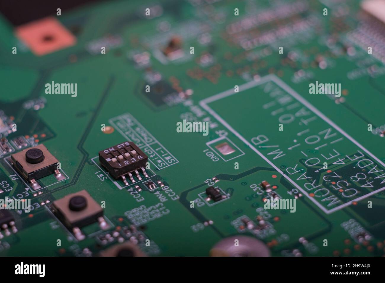 Part of an electronic printed circuit board with many electrical components. Stock Photo