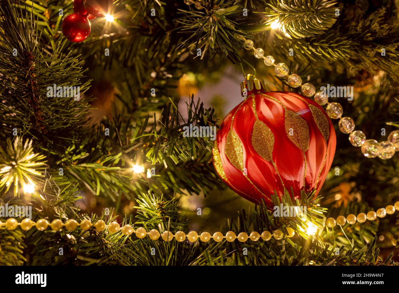Lighted Christmas tree with holiday ornaments Stock Photo Alamy