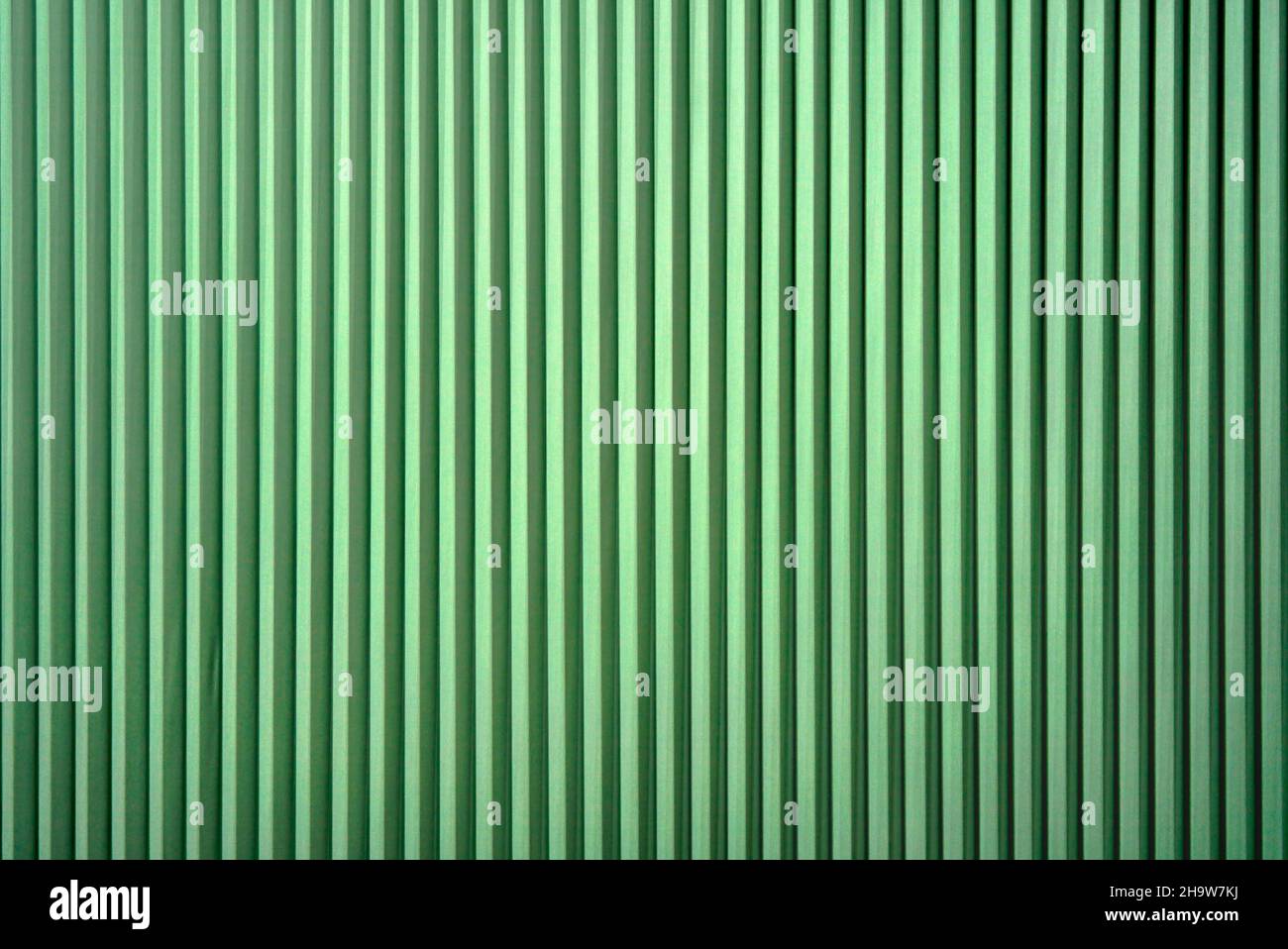 bright vertical folding blinds bright green Stock Photo